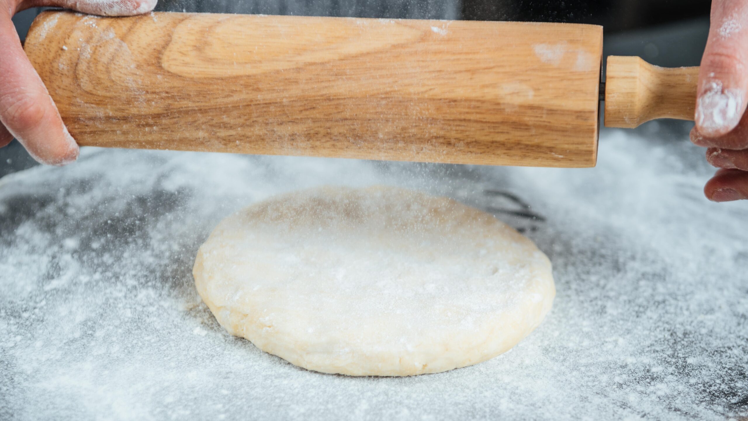 male hands rolling out dough on the table 2021 08 26 18 19 38 utc min 2 edited scaled