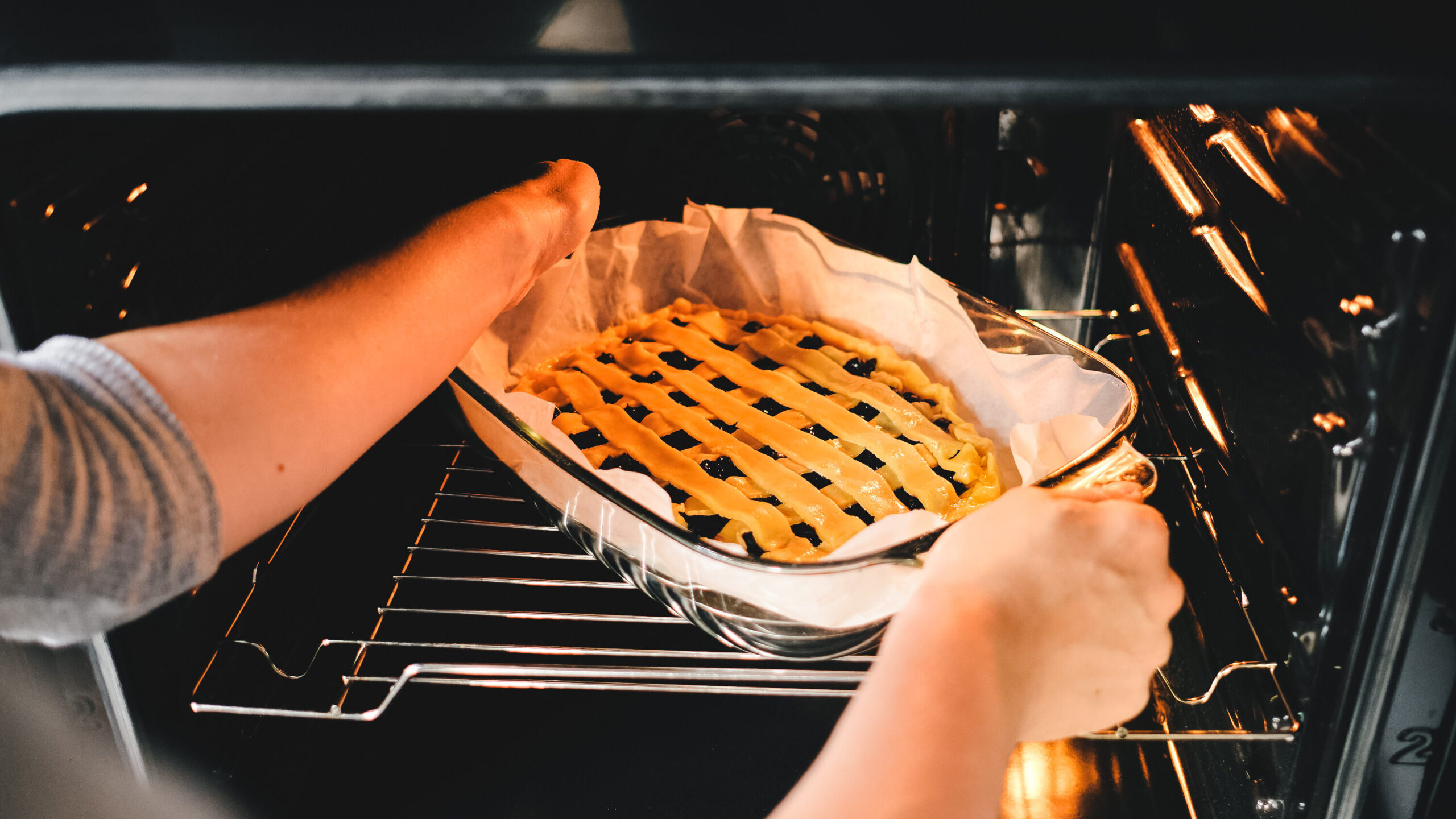 young woman puts the homemade cake in the oven 2021 08 27 19 12 58 utc edited scaled